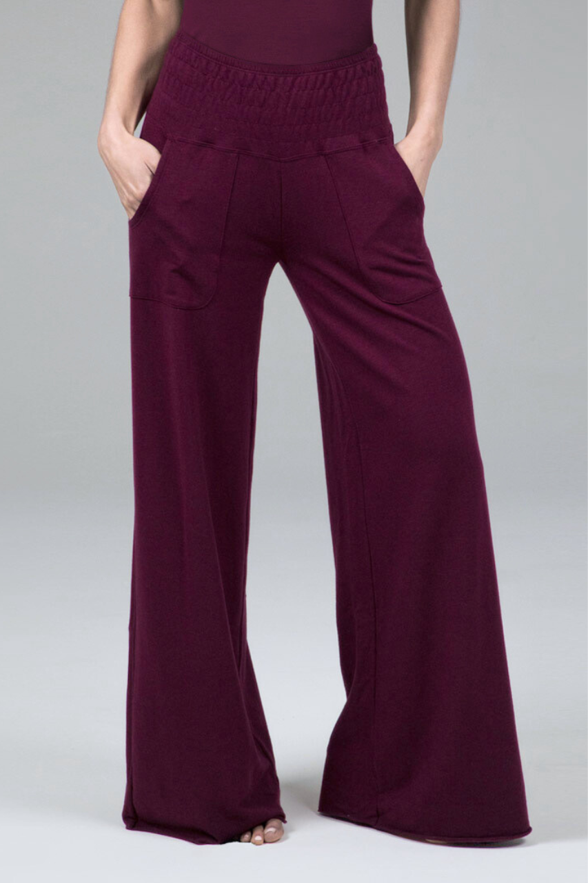 Maroon wide-leg pants worn by a person on a plain background