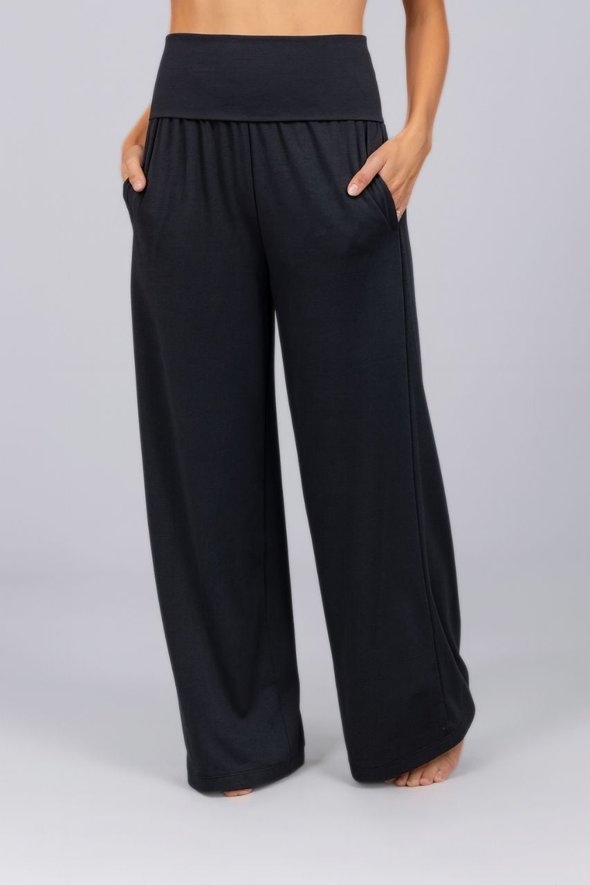 Black wide-leg pants worn by a person on a plain background