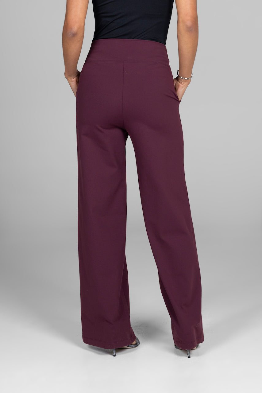 Maroon wide-leg pants worn by a person on a gray background