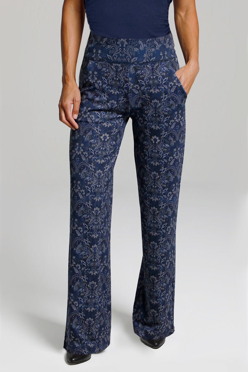 Navy floral-patterned pants worn by a person on a light gray background