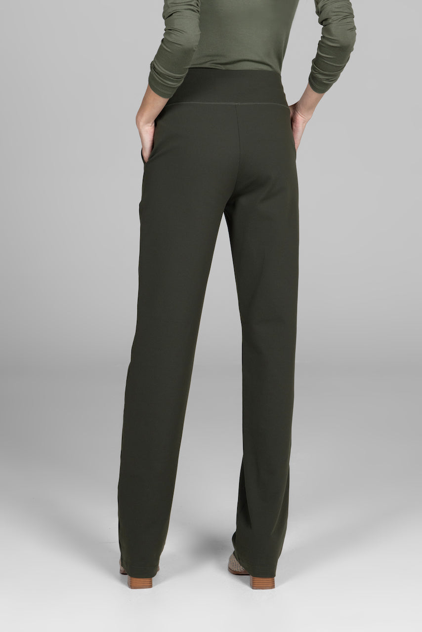 Dark green pants worn by a person on a gray background