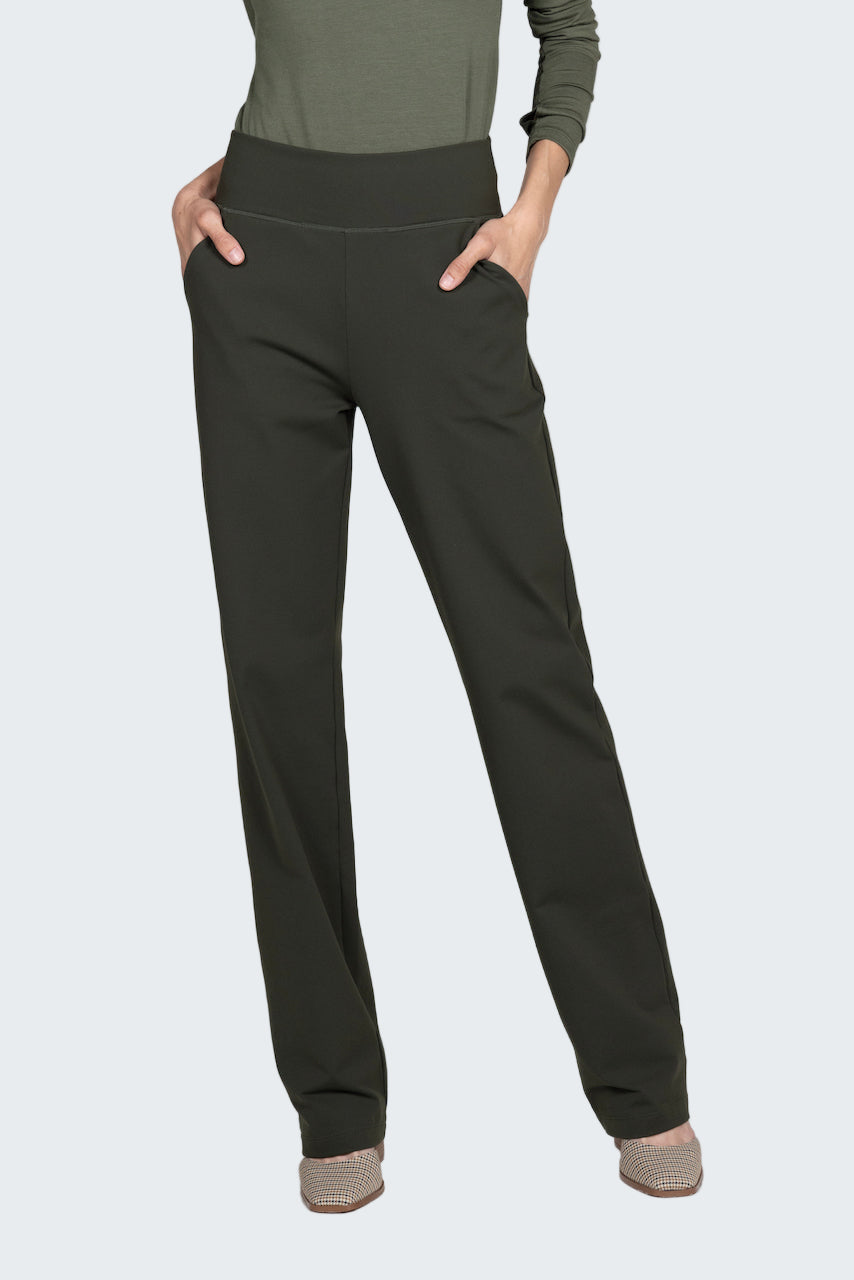 Dark gray pants worn with a green top on a light gray background