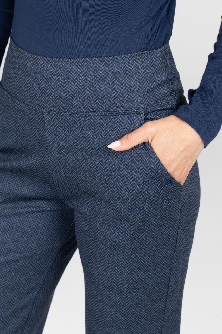 Navy herringbone pants with a plain background