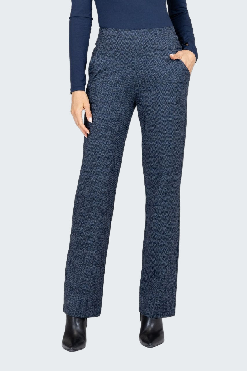 Person wearing blue pants and a dark top on a white background