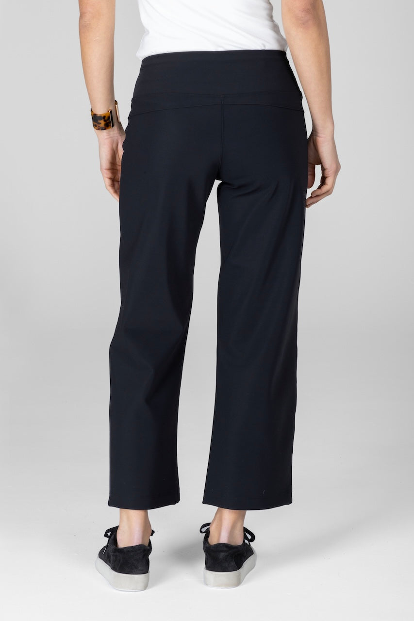 Person wearing black pants on a white background