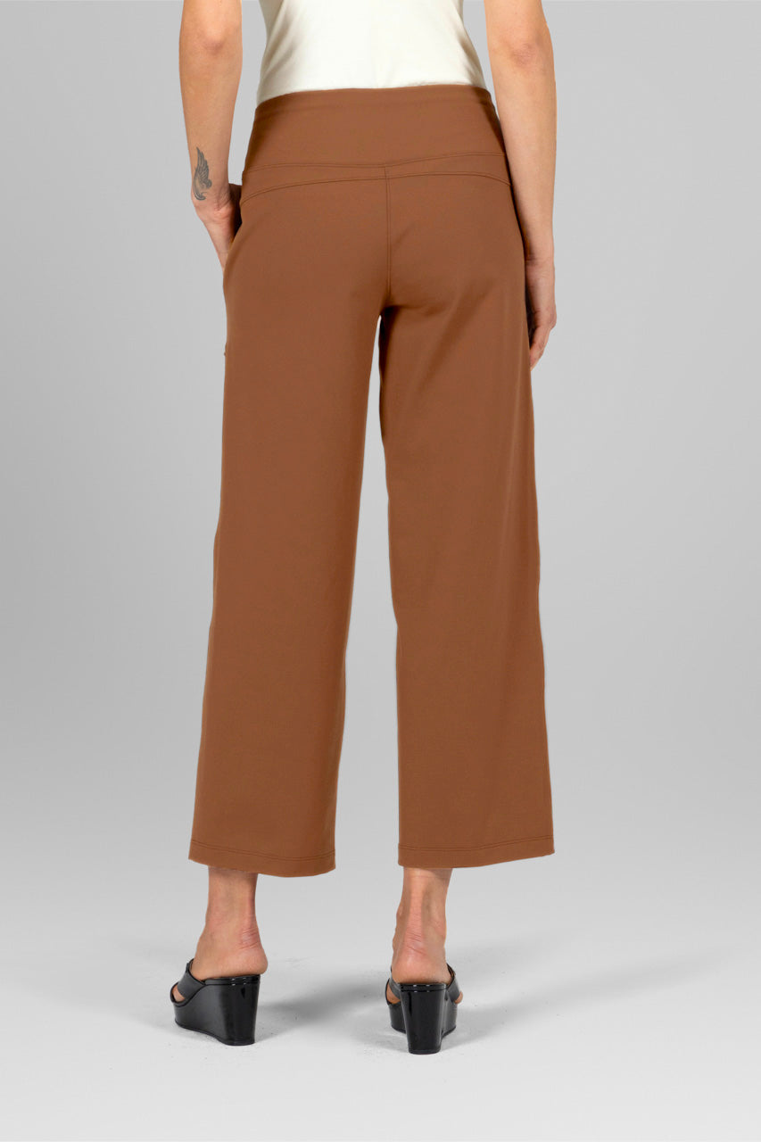 Brown pants worn by a person on a gray background