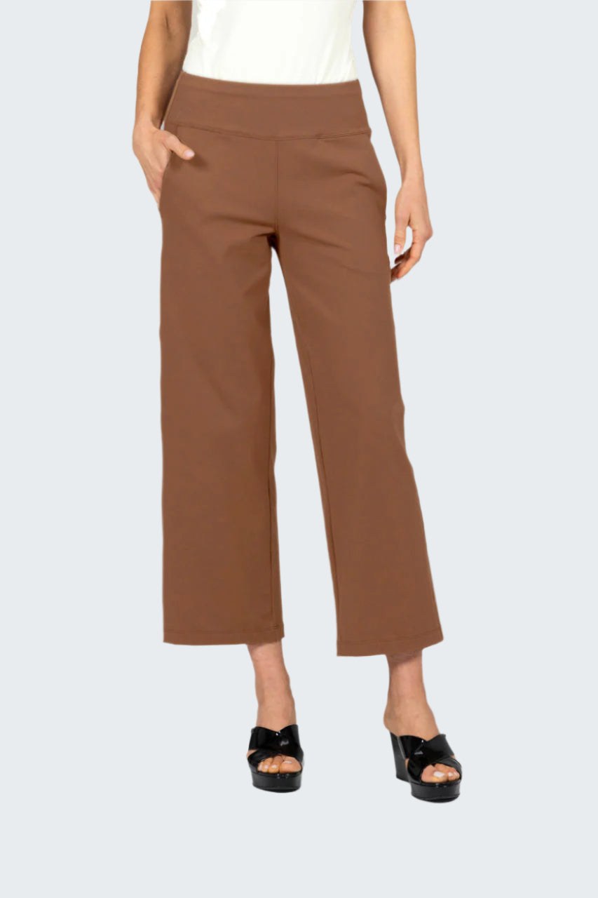 Brown pants worn by a person on a gray background