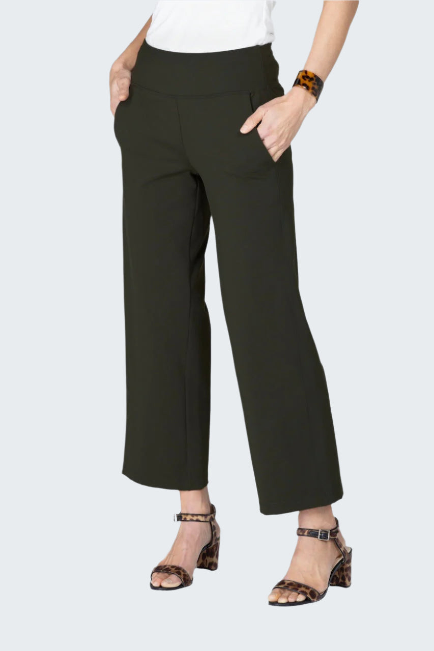 Person wearing black pants on a gray background
