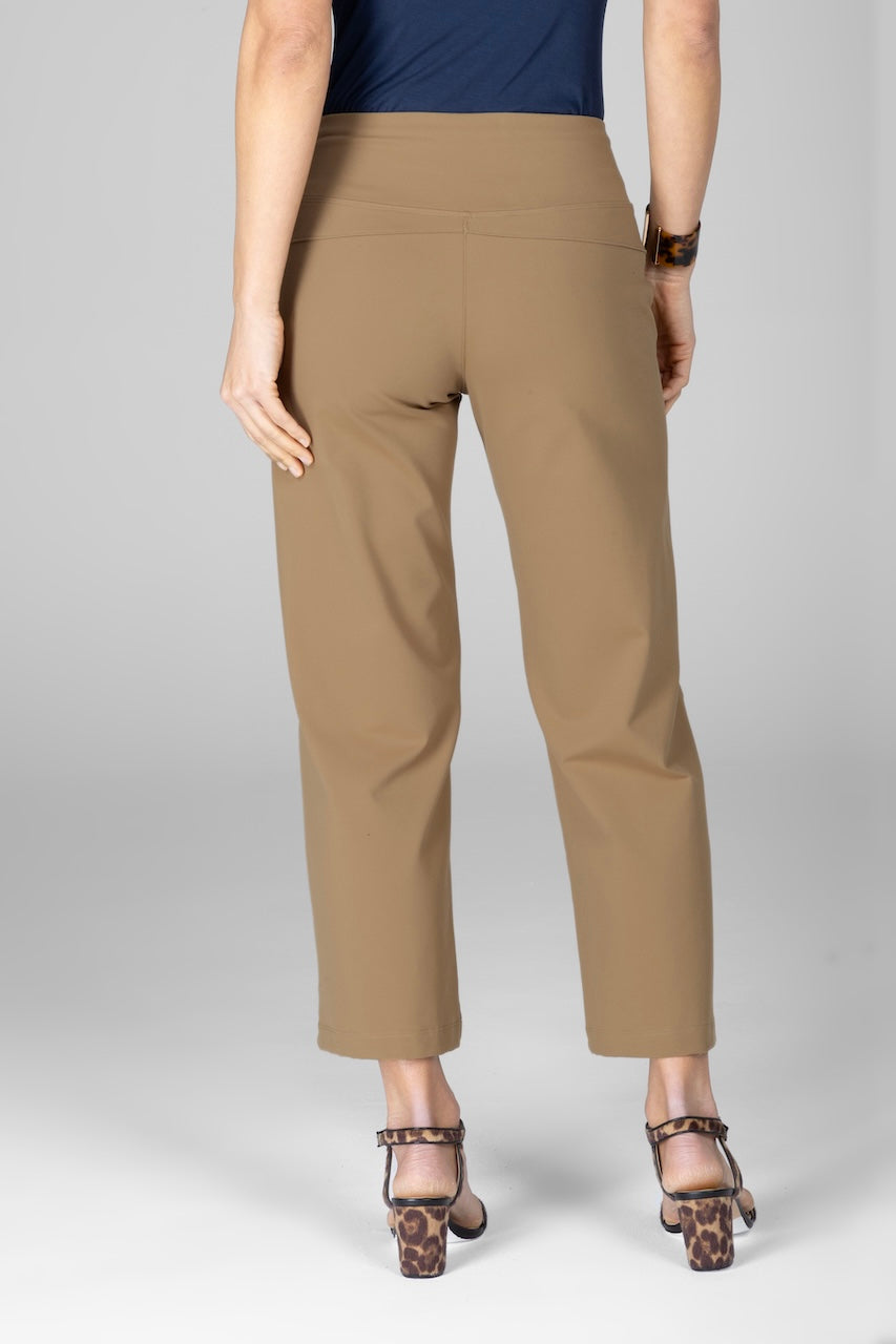 Beige pants worn by a person on a gray background