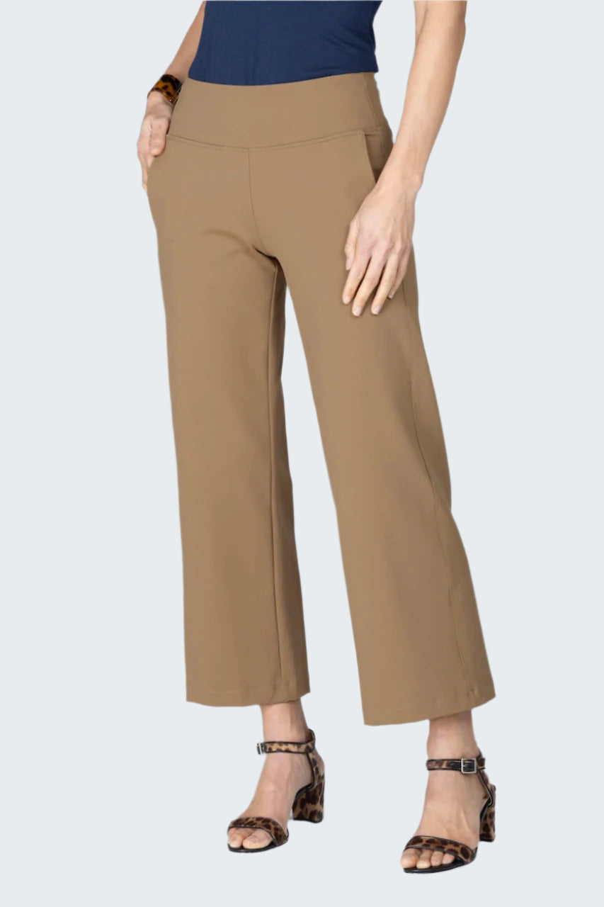Beige pants worn by a person on a white background