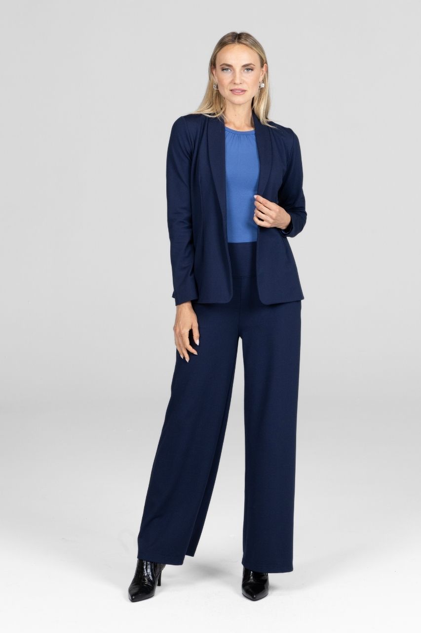 Woman wearing a navy blue suit with a white background