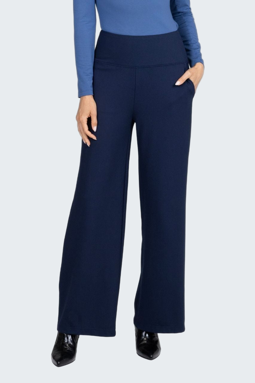 Navy blue wide-leg pants worn with a blue top on a white background