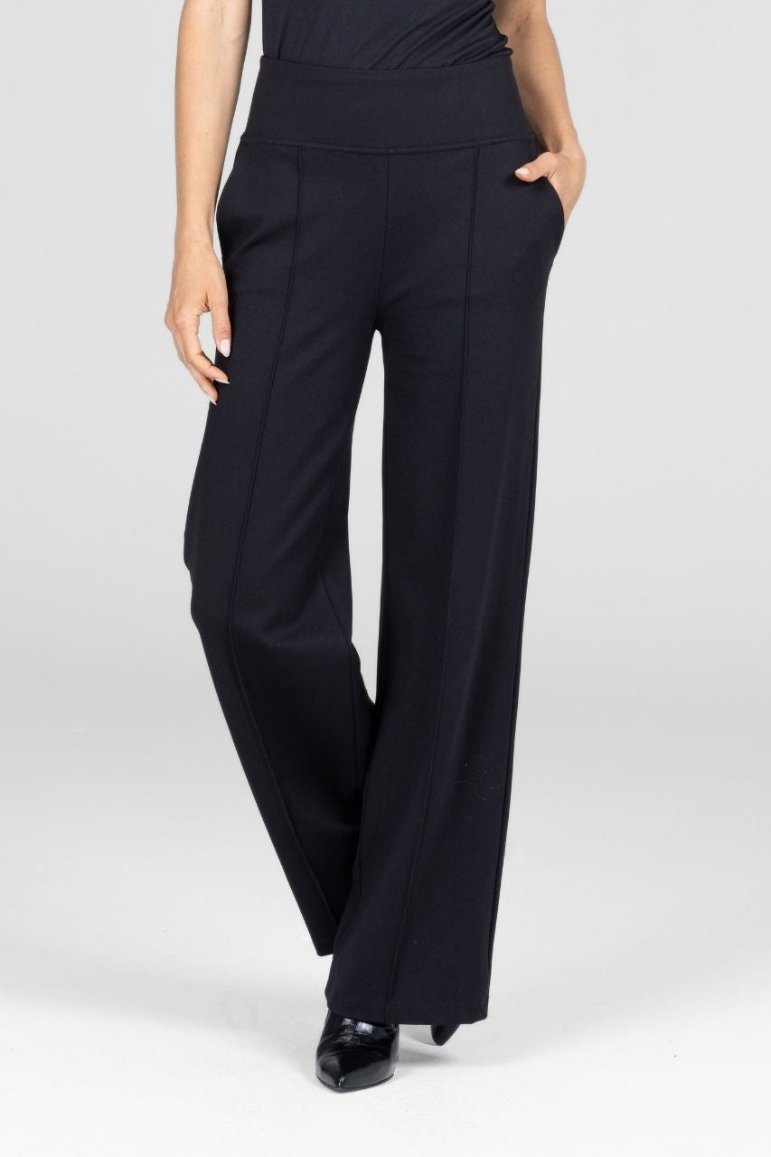 Black wide-leg pants worn by a person on a white background