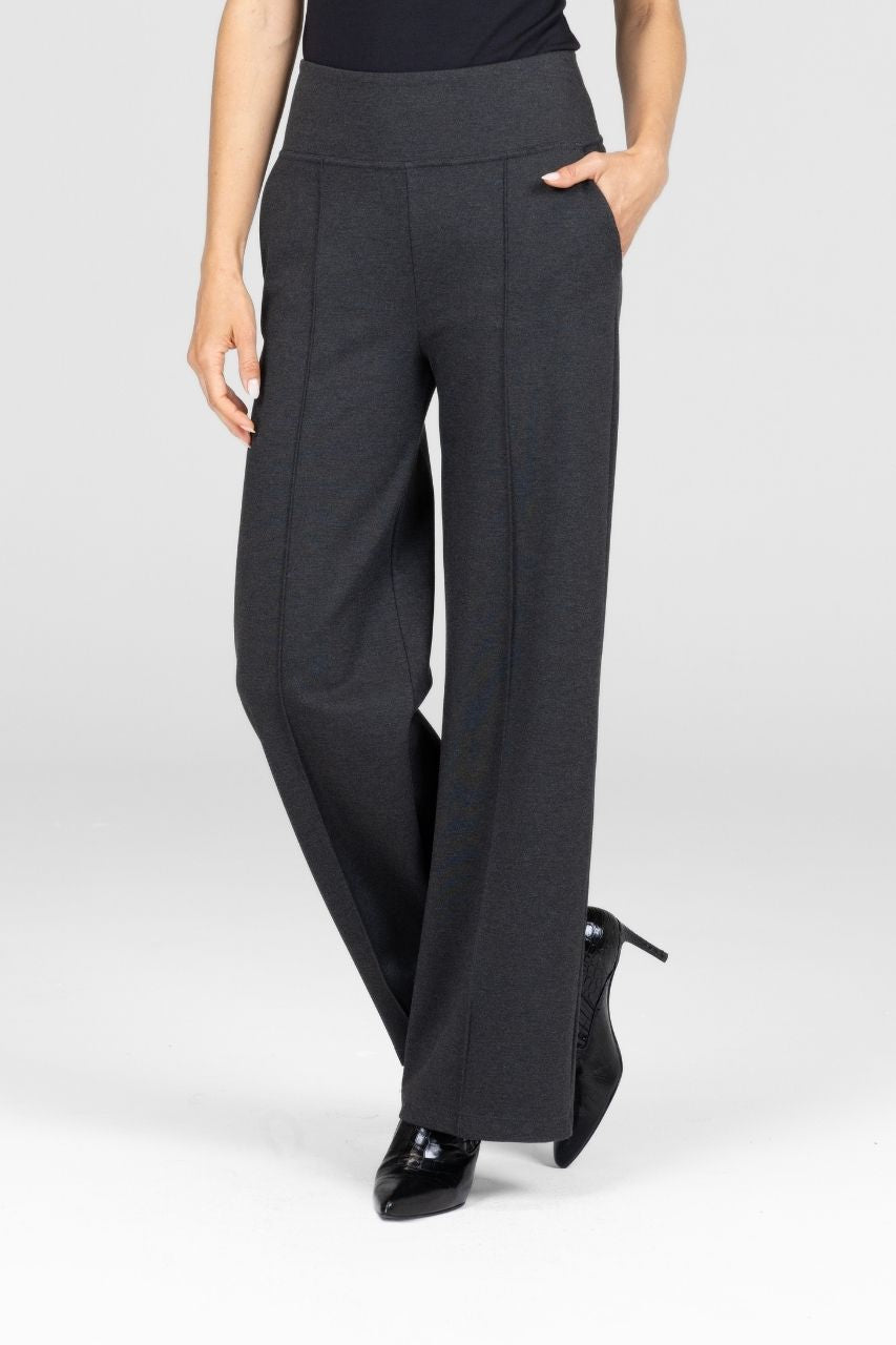 Person wearing gray wide-leg pants on a white background