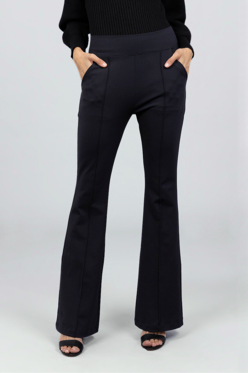 Black pants worn by a person on a white background