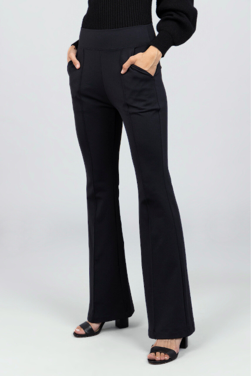 Black pants worn by a person on a white background