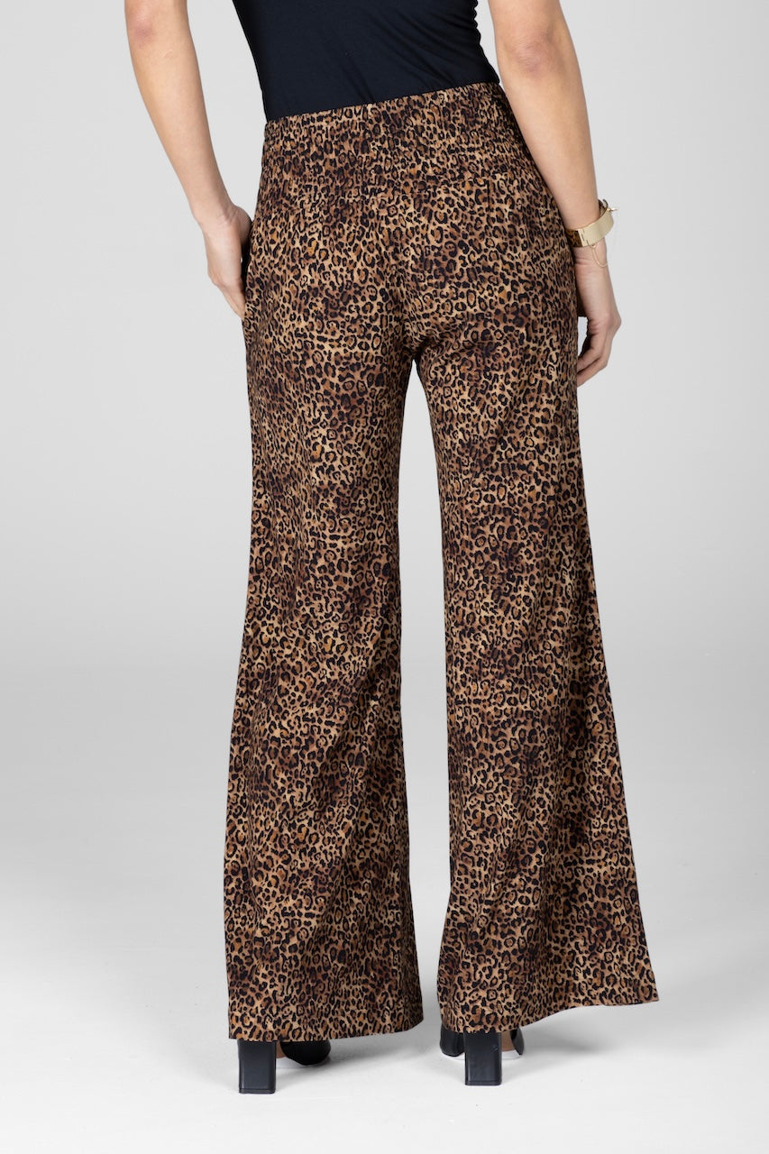 Leopard print pants worn by a person on a white background