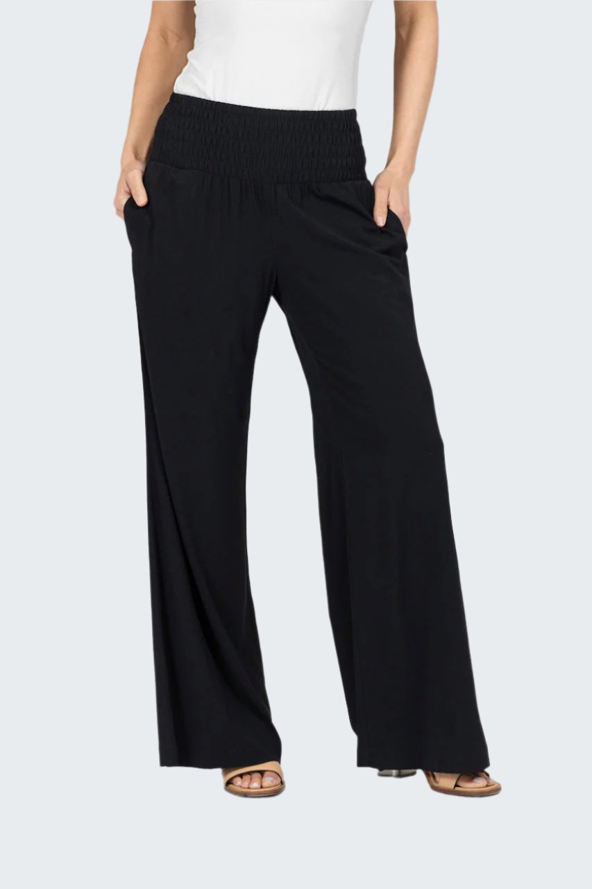 Black wide-leg pants worn by a person on a white background