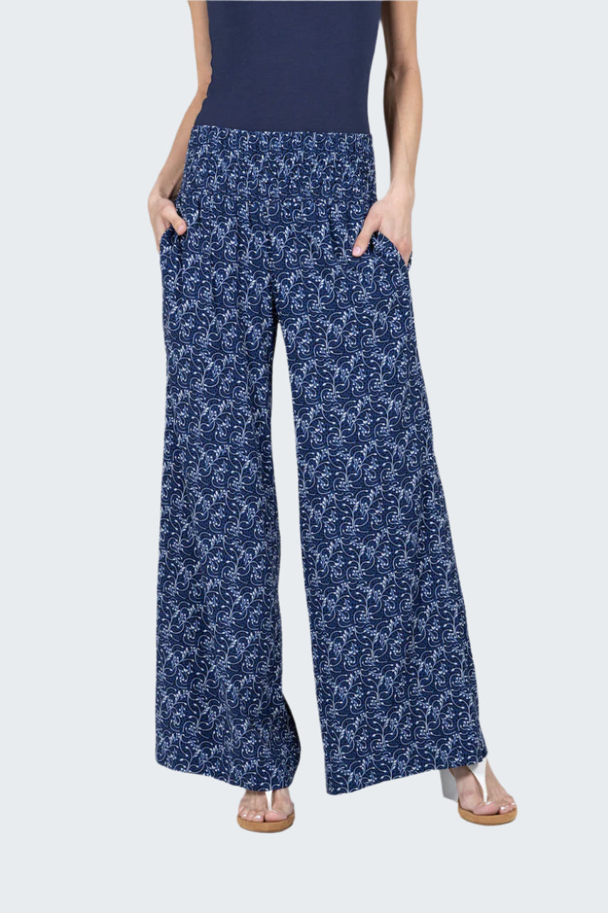 Person wearing blue floral-patterned pants on a gray background