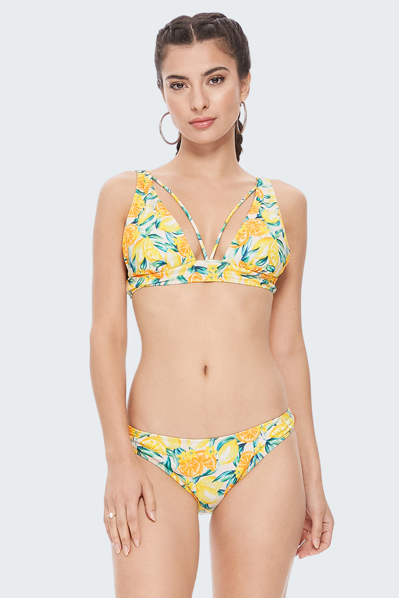 Woman wearing a yellow floral bikini on a white background