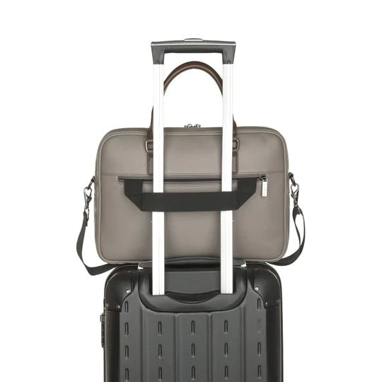 Gray suitcase with a black interior and handle extended on a white background