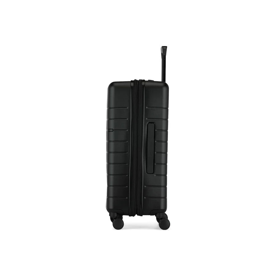 Black suitcase with a textured surface on a white background
