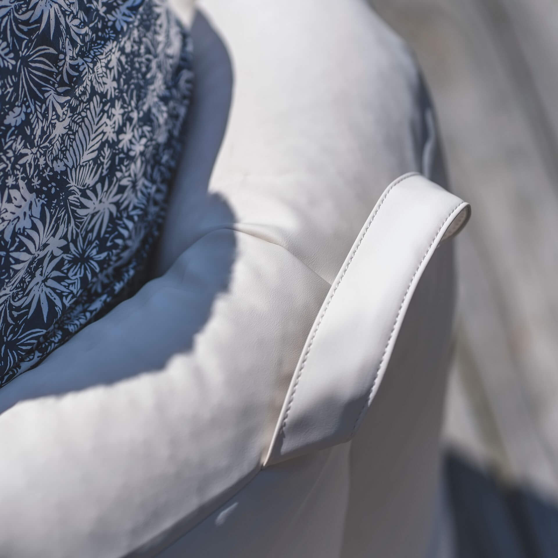 Close-up of a gray car seat with floral-patterned headrest