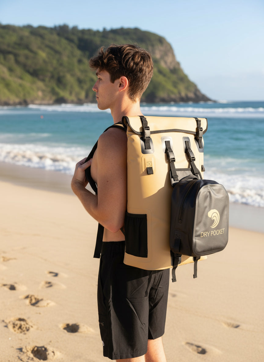 Person wearing a beige backpack with a black dry pocket attachment on a white background