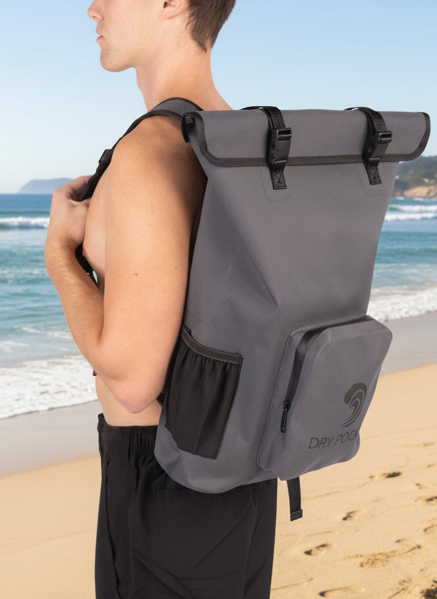 Person wearing a gray backpack with a visible brand logo on a white background