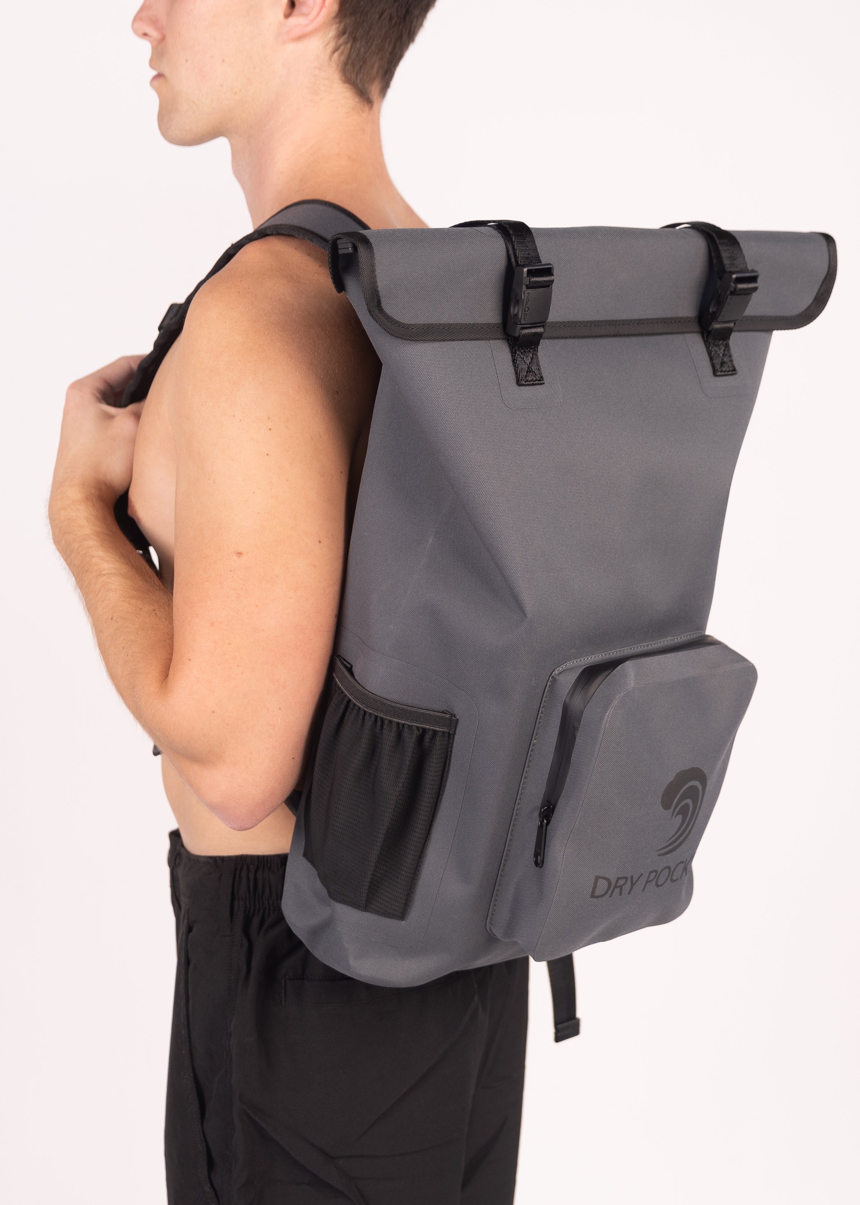 Person wearing a gray backpack with a visible brand logo on a white background