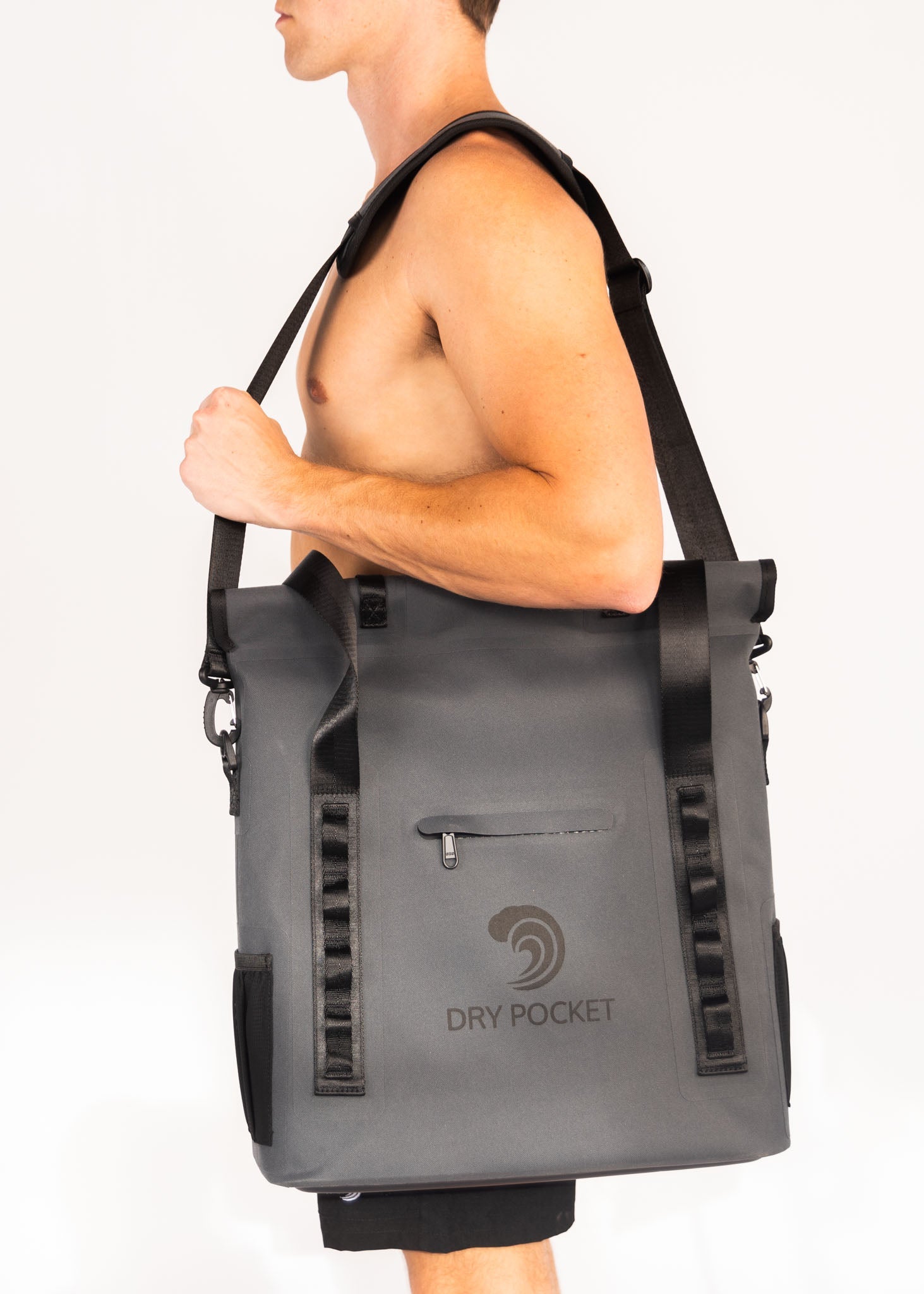 Person carrying a gray Dry Pocket bag on a white background