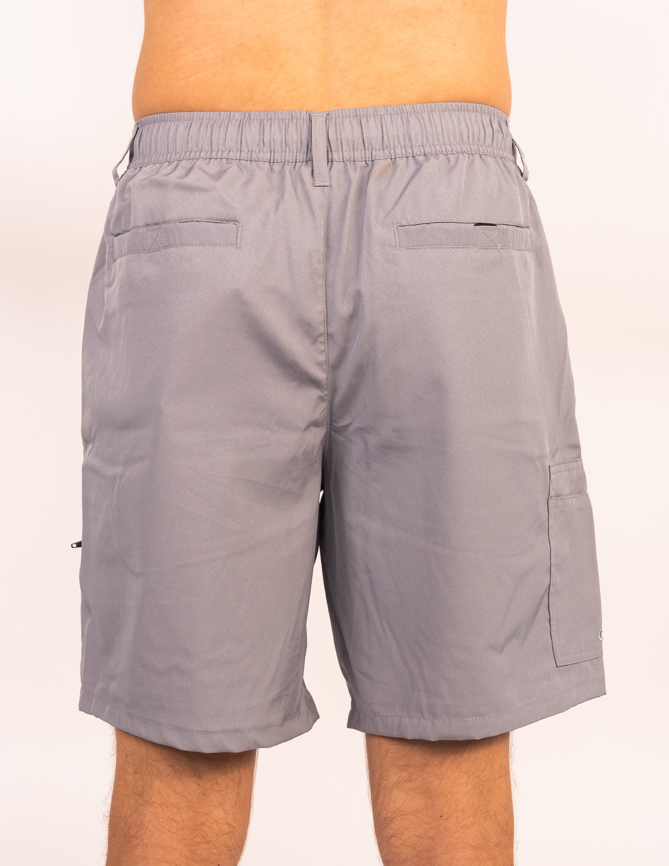 Gray shorts worn by a person on a white background