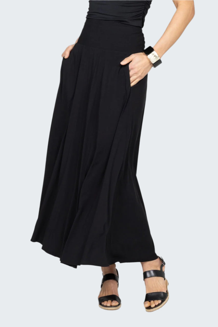 Person wearing a black skirt on a gray background