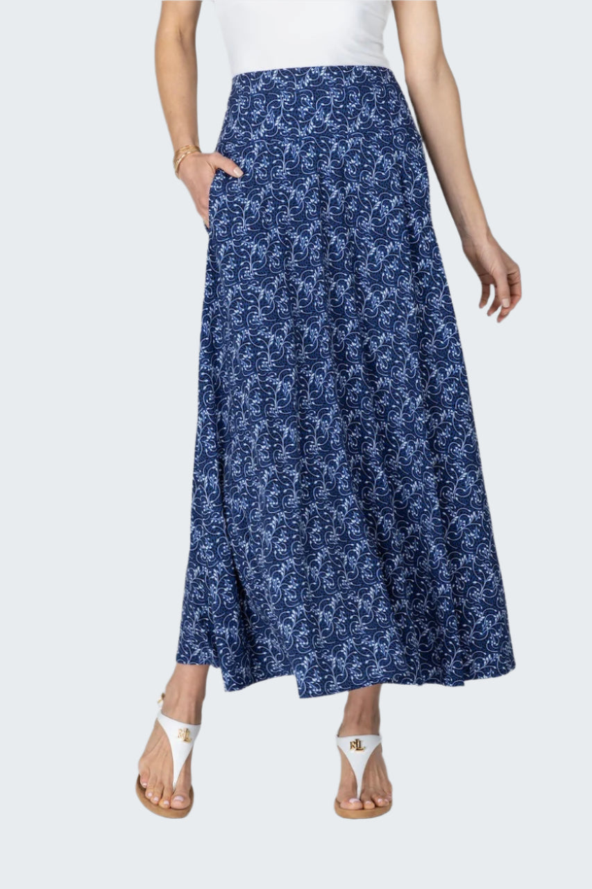 Woman wearing a blue floral skirt on a white background