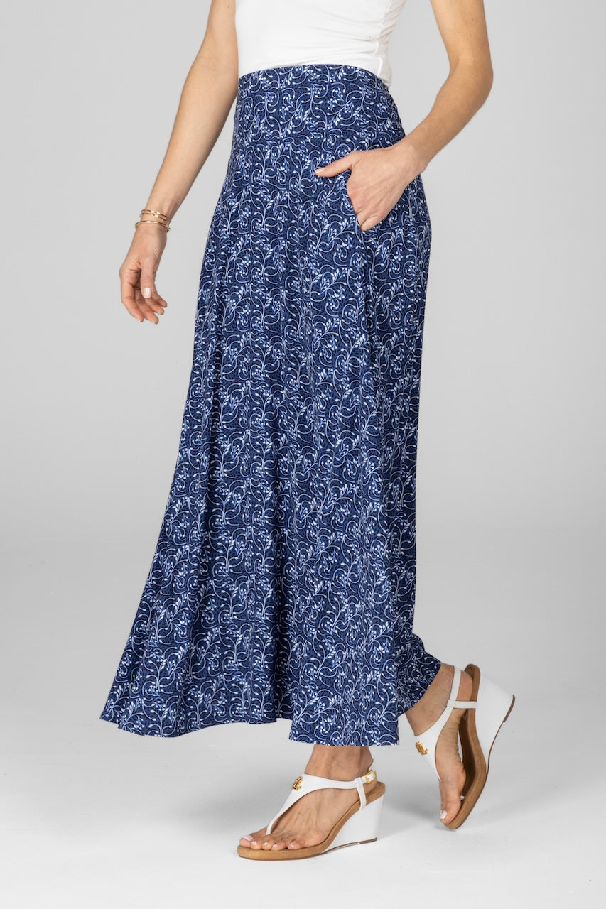 Woman wearing a blue floral skirt on a gray background