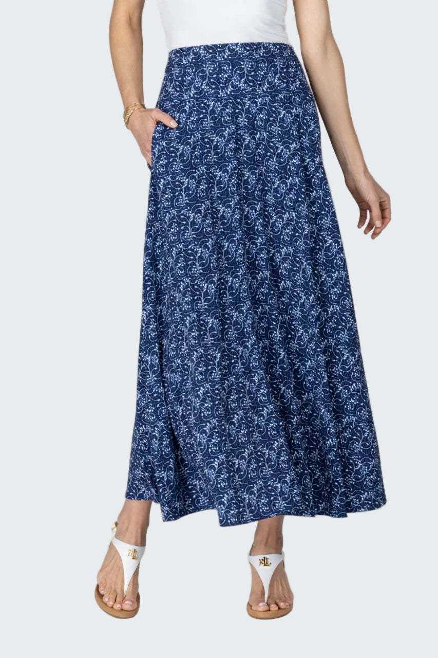 Woman wearing a blue floral skirt on a beige background