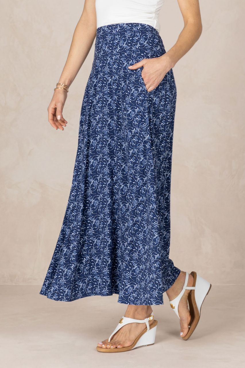 Woman wearing a blue floral skirt on a beige background