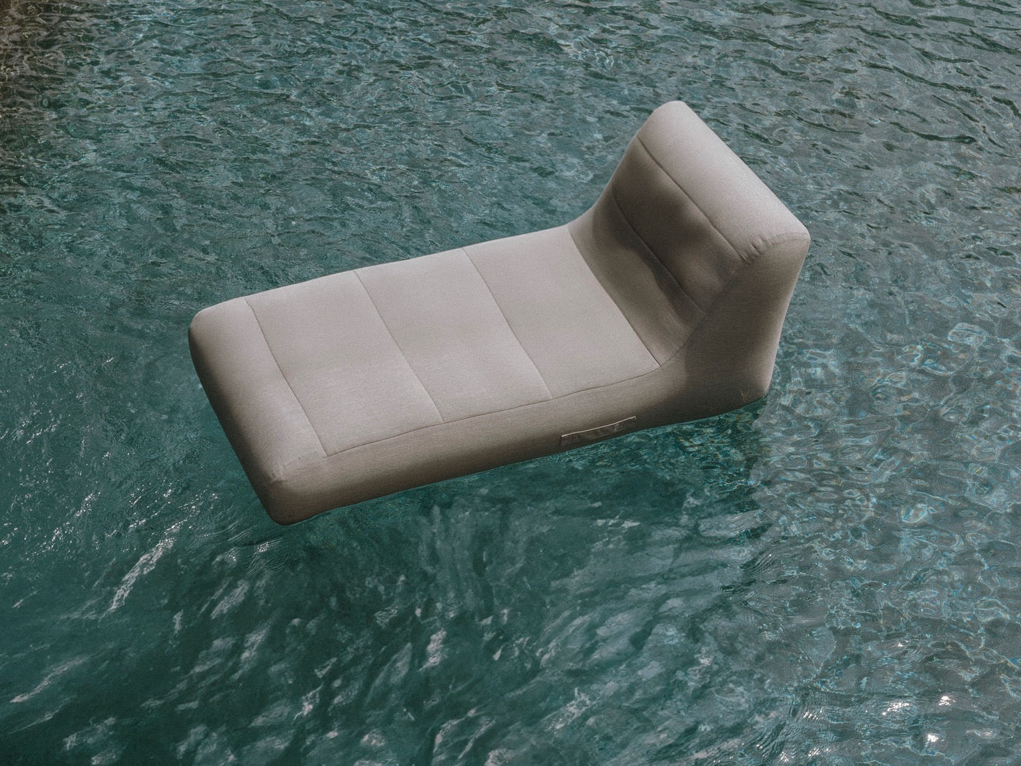 Beige cushion floating on water