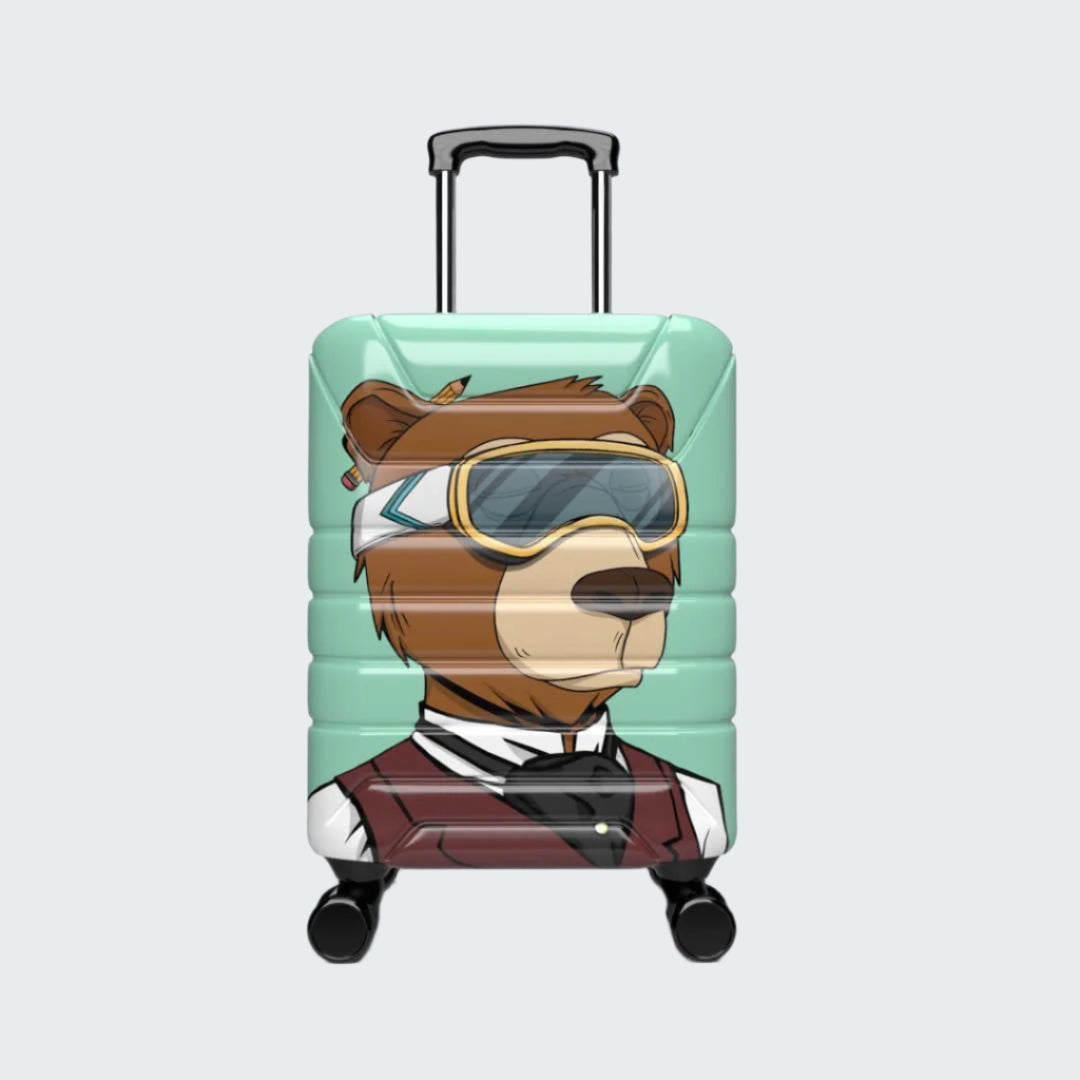 Suitcase with a cartoon bear design wearing goggles on a white background