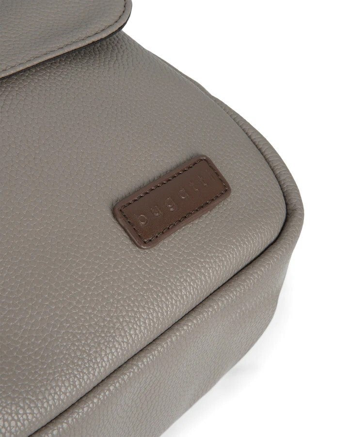 Close-up of a gray textured bag with a brown label on a white background