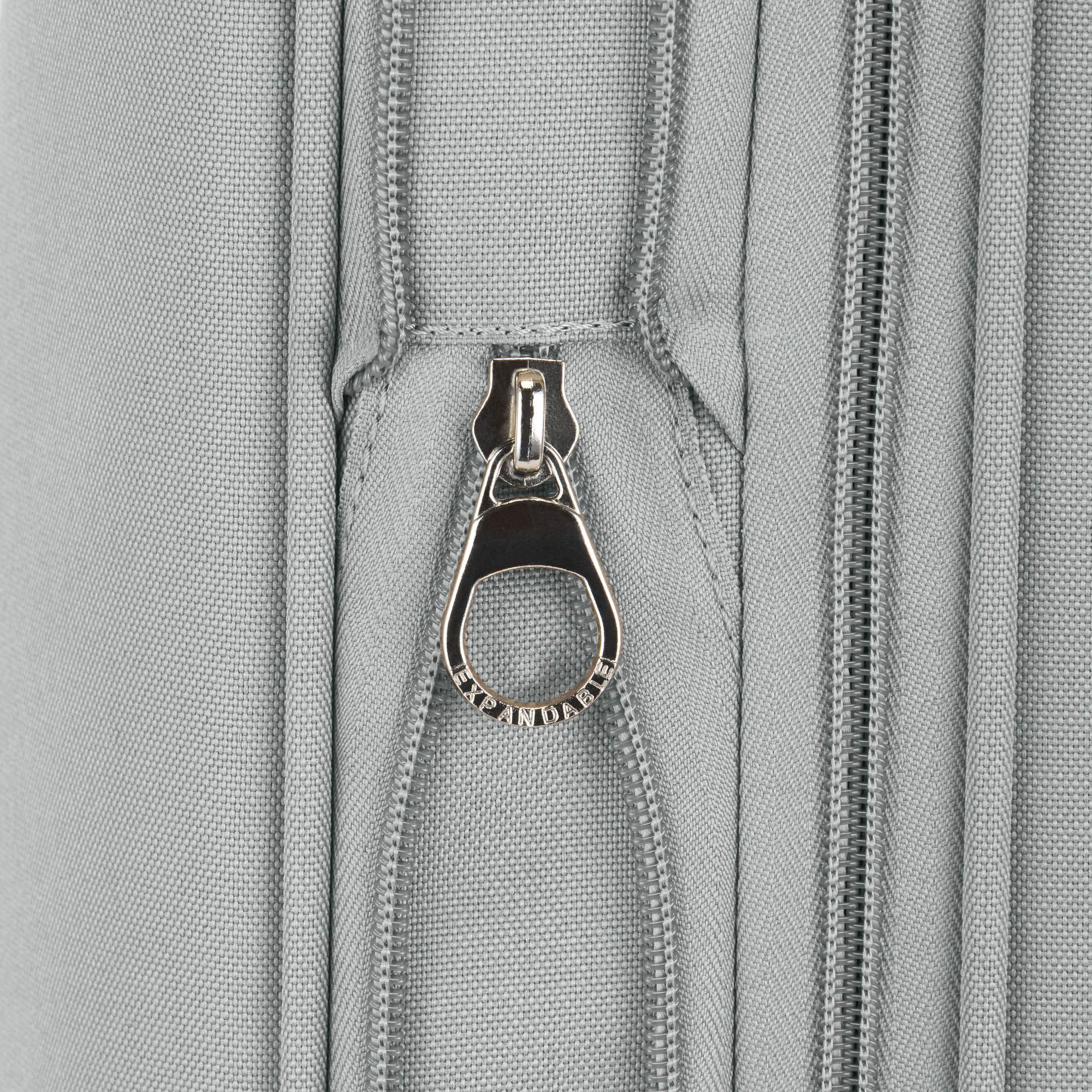 Close-up of a zipper on a gray fabric surface
