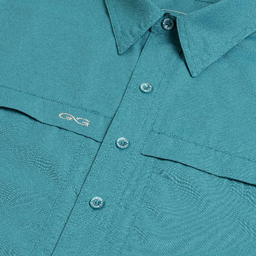 Teal shirt with button details and a brand logo on a plain background