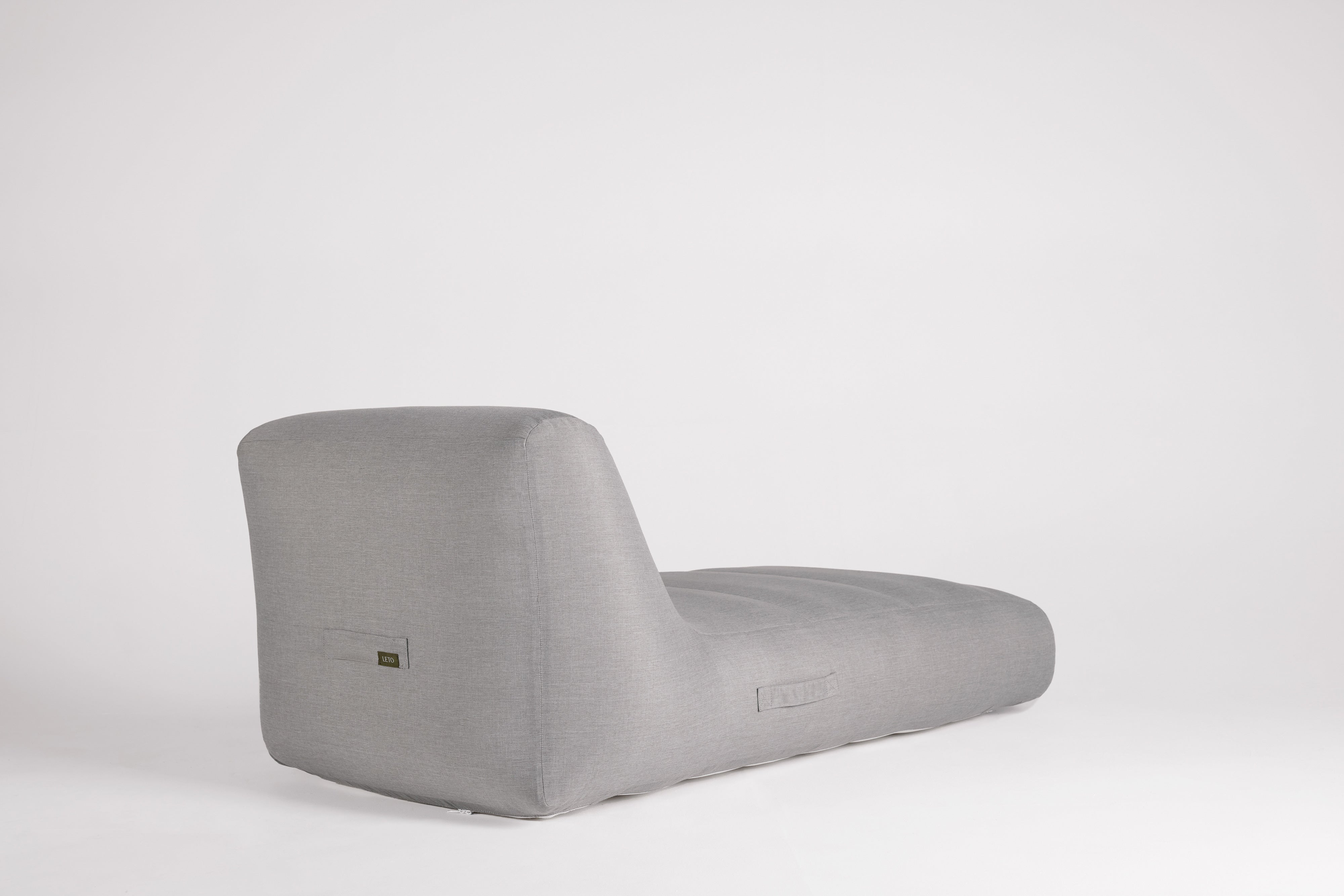 Gray wedge-shaped cushion on a white background