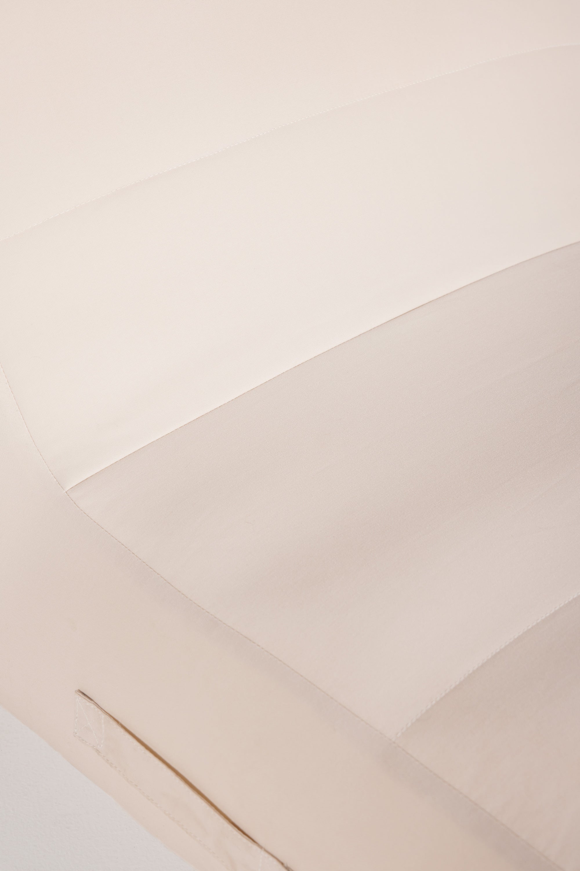 Close-up of beige fabric with a subtle pattern