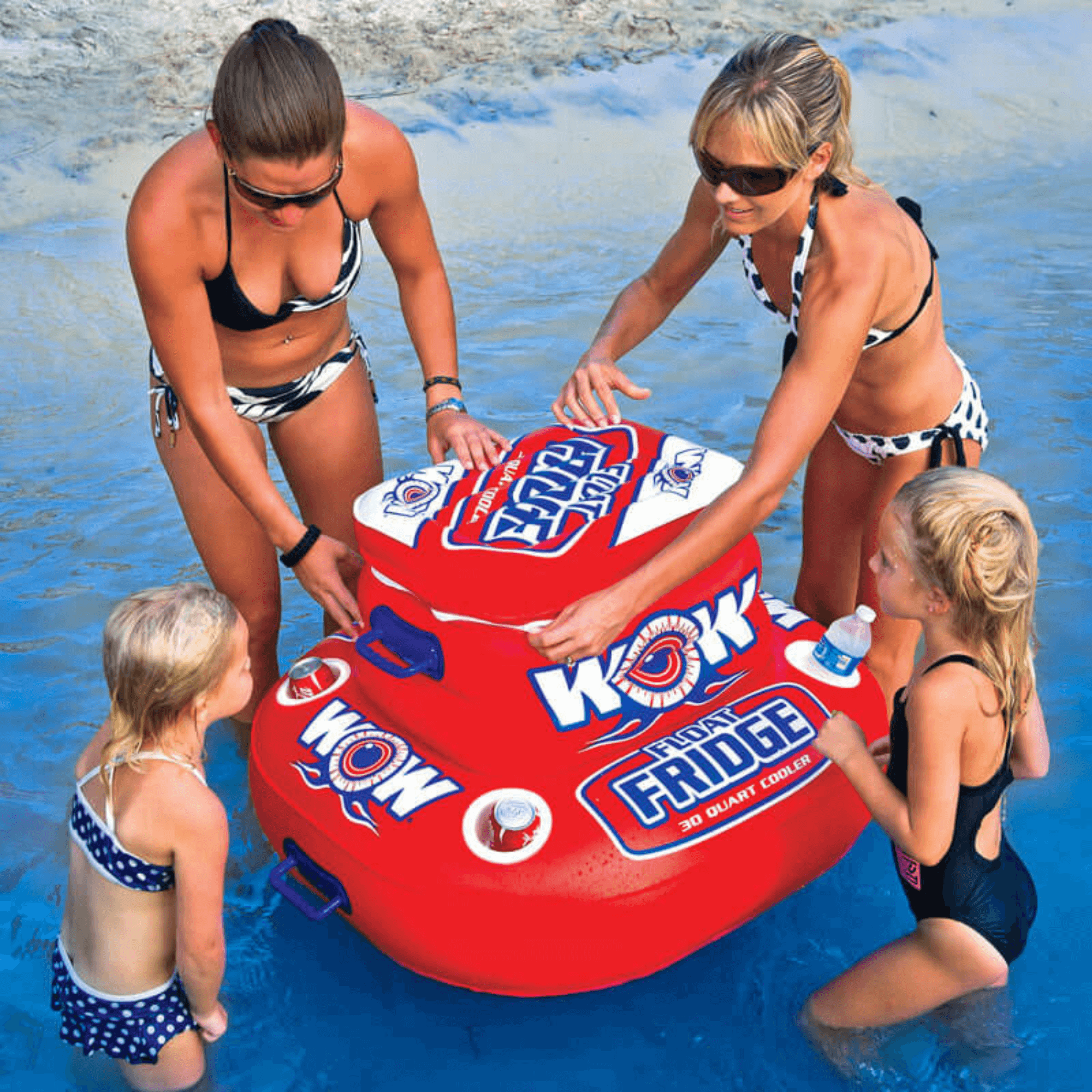 Two women and two children playing with a Woky Wow inflatable cooler in a pool.