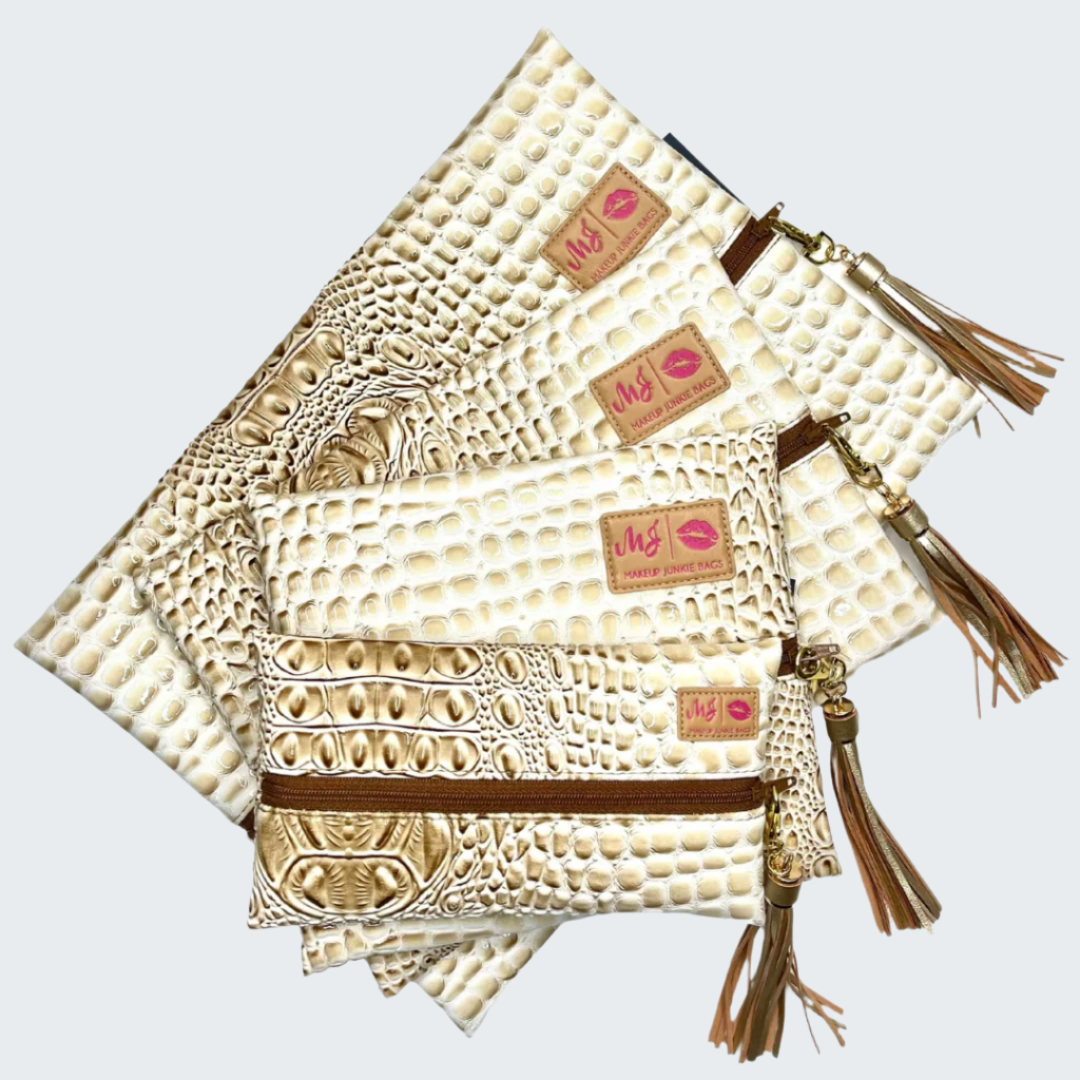 Set of beige textured pouches with tassels and visible brand logo on a white background