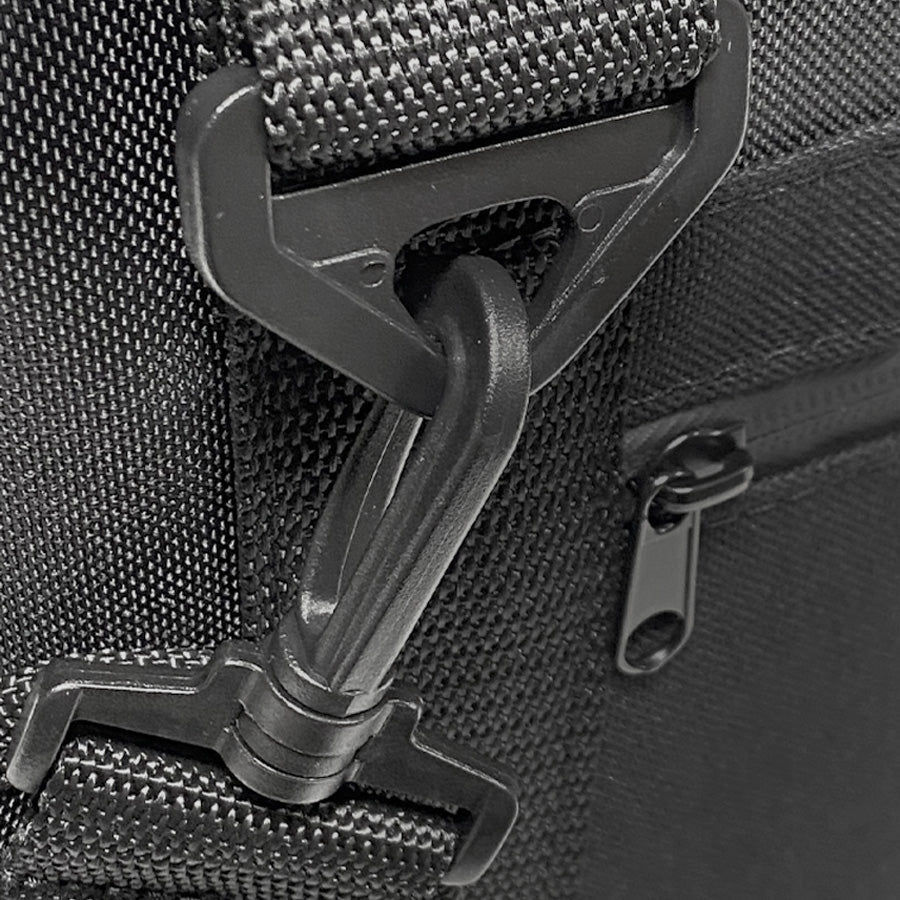 Close-up of a black bag with a buckle and zipper