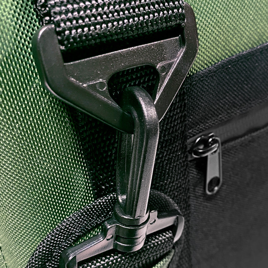 Close-up of a green bag with a black buckle and zipper
