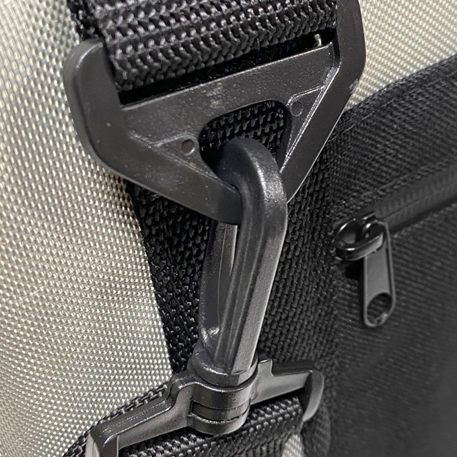 Close-up of a black strap buckle on a beige bag