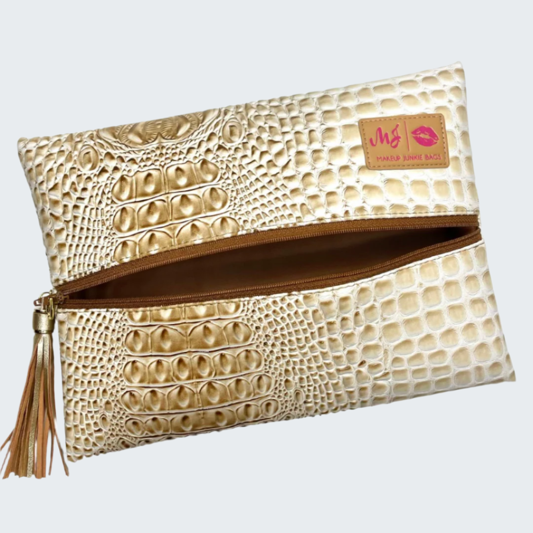 Beige textured clutch bag with a tassel on a white background